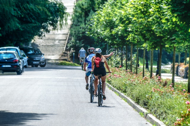 Some cyclists using the bike lane next to cars.