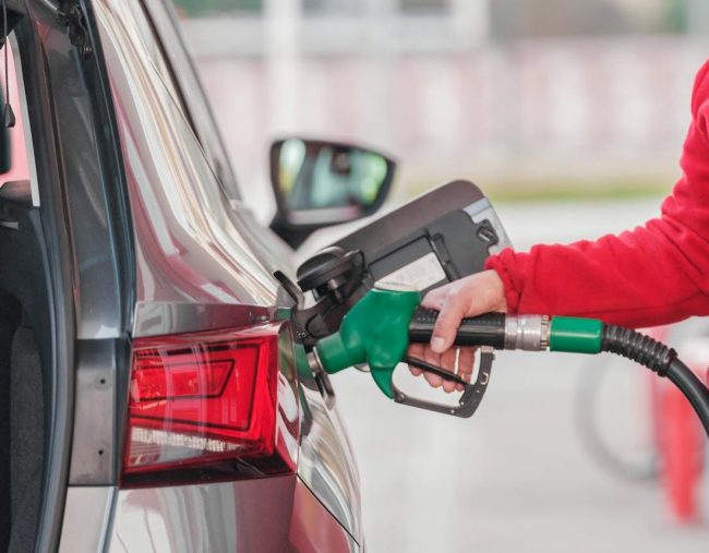 A person refueling their car.