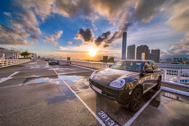 A car parked in a large parking lot.