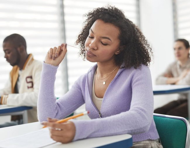A woman taking an exam on her desk.