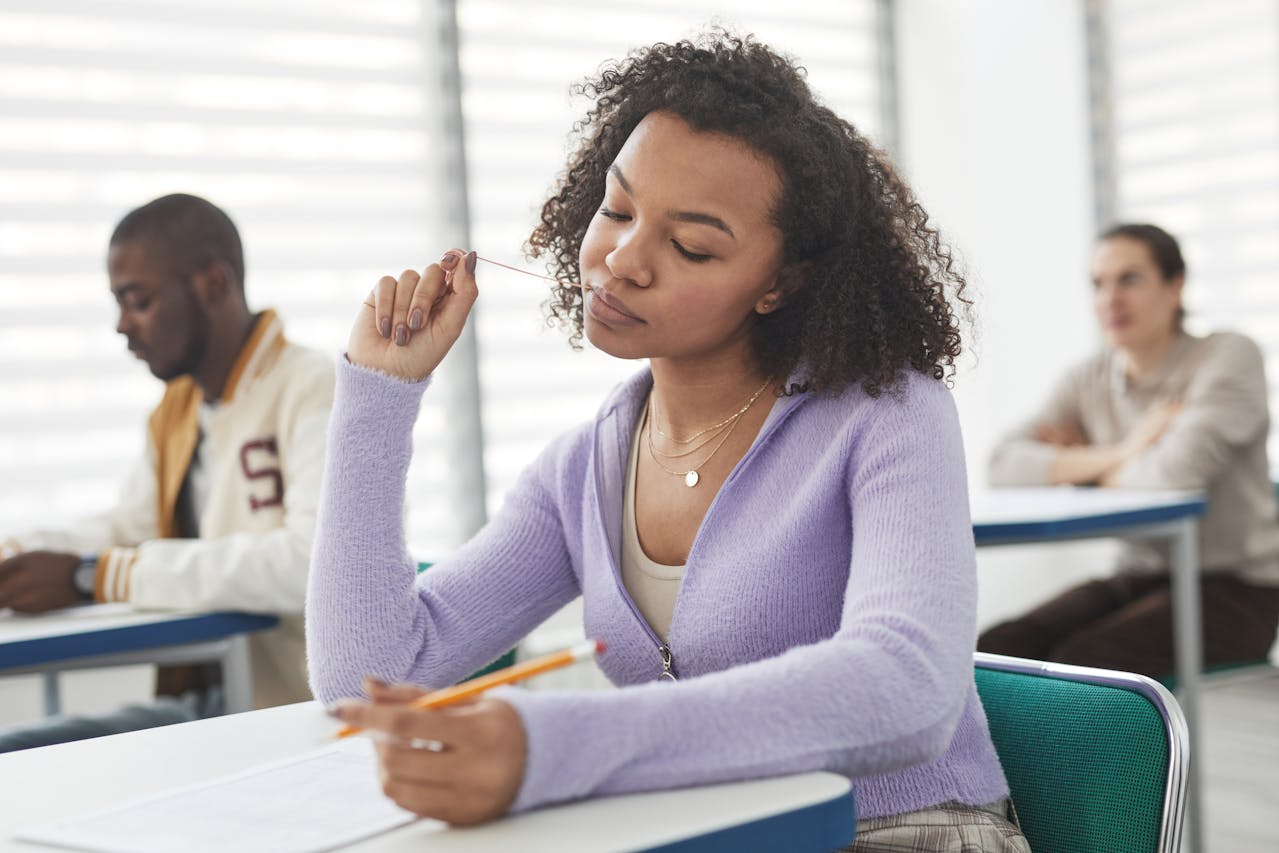 A woman taking an exam on her desk.
