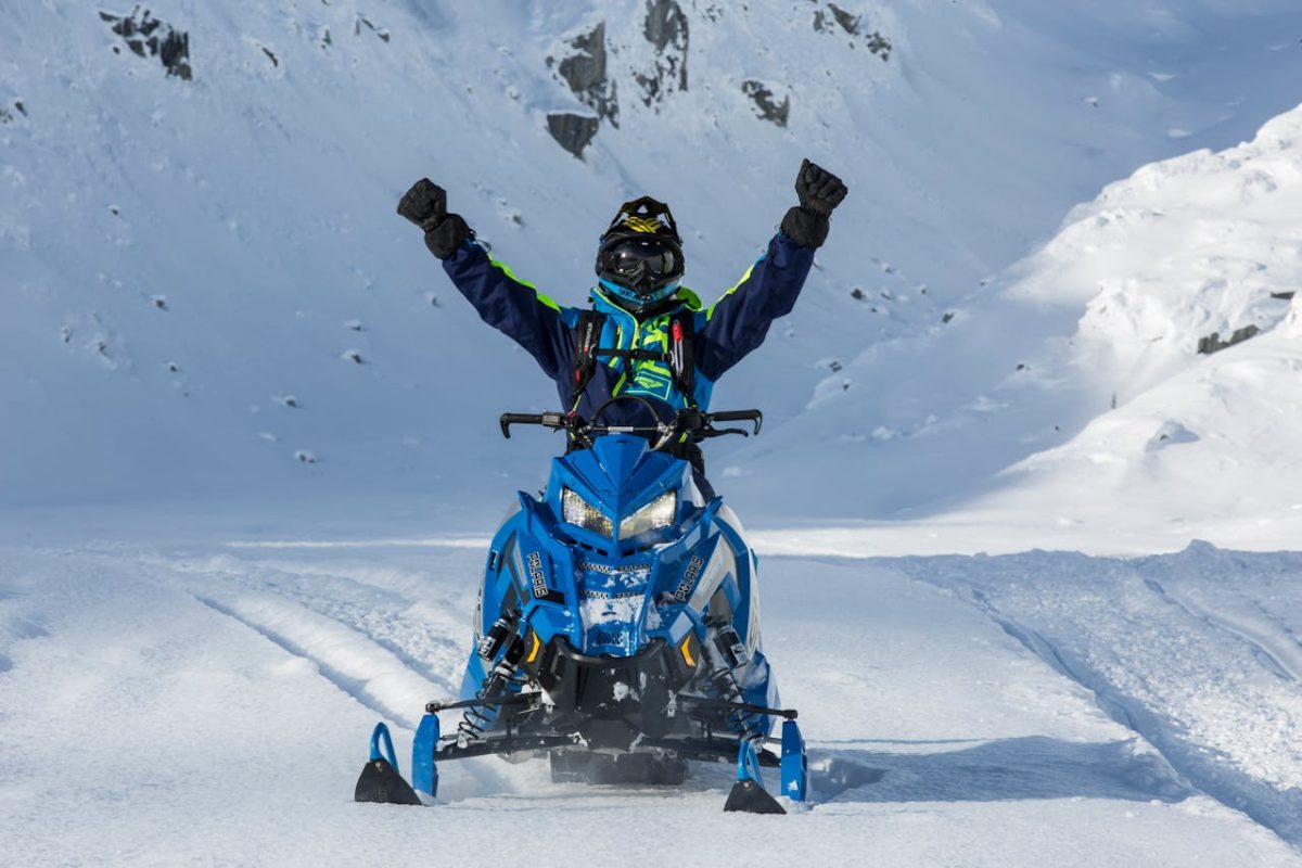 A person riding a snowmobile.