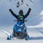 A person riding a snowmobile.