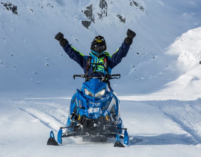 A person riding a snowmobile.