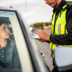 A woman getting a traffic ticket.