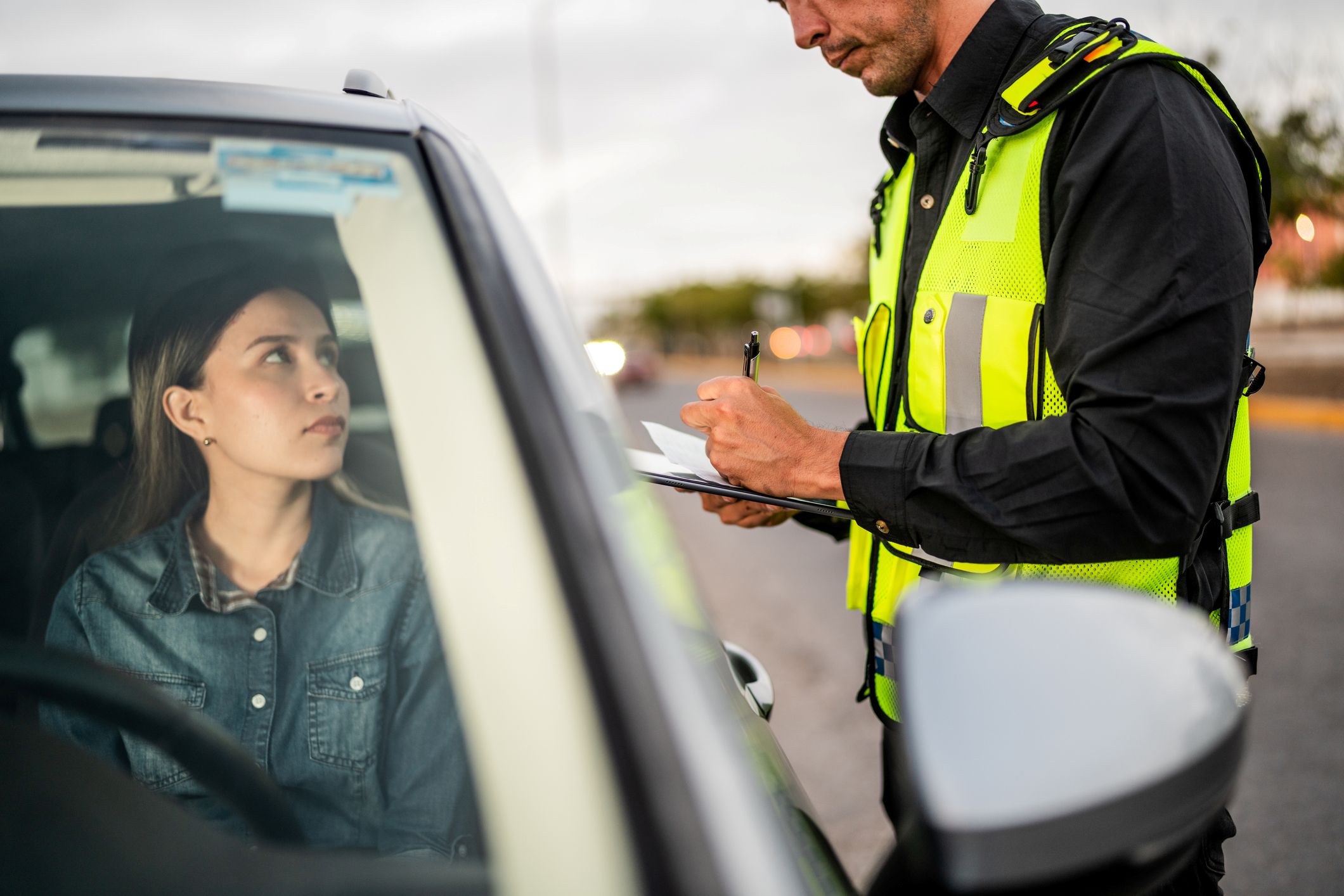 A woman getting a traffic ticket.